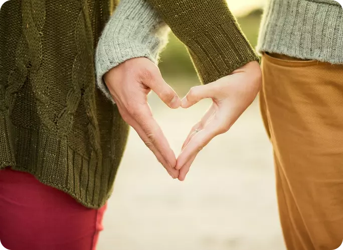couples hands' forming a love heart shape